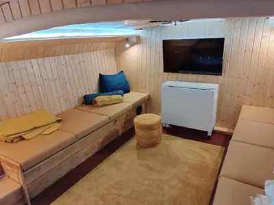 a living room with a couch and a tv at SLEEPBOAT LuxLife Yatch in Porto