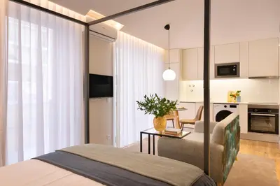a bedroom with a bed and a table and a kitchen at Cactus Apartment, by Bolhão Residences in Porto
