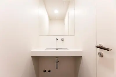 a white bathroom with a sink and a shower at Aliados Premium 1BR w/ Terrace by LovelyStay in Porto