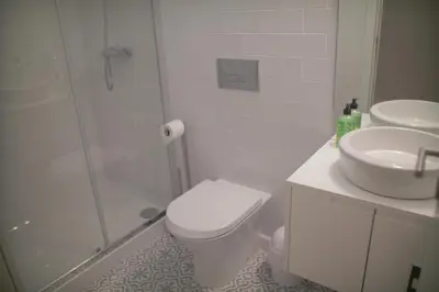 a bathroom with a shower and a toilet and a sink at CASA SANTO ILDEFONSO in Porto