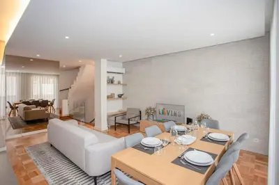 a living room with a dining table and a couch at Liiiving in Porto - Design Bright House in Porto