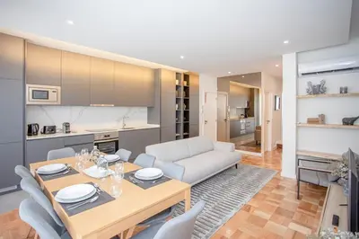 a kitchen and living room with a table and chairs at Liiiving in Porto - Design Bright House in Porto