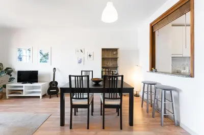 a dining room with a black table and chairs at Dream Views of Porto - Private Apt in Gaia by Lisbeyond in Vila Nova de Gaia