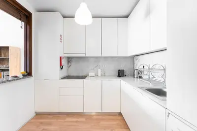 a white kitchen with white cabinets and a sink at Dream Views of Porto - Private Apt in Gaia by Lisbeyond in Vila Nova de Gaia