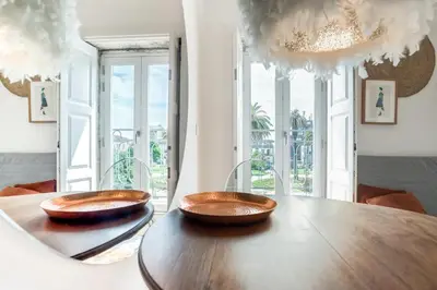 two bowls on a wooden table in a room with windows at Studio Duplex w/ AC In Praça República by LovelyStay in Porto