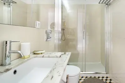 a bathroom with a tub and a sink and a shower at Studio Duplex w/ AC In Praça República by LovelyStay in Porto