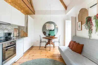 a living room with a table and a couch at Studio Duplex w/ AC In Praça República by LovelyStay in Porto