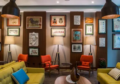 a living room with colorful furniture and pictures on the wall at The Editory Artist Baixa Porto Hotel in Porto