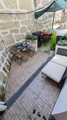 a patio with chairs and tables and an umbrella at KirasHouse in Porto