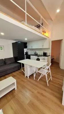 a living room with a white table and a couch at KirasHouse in Porto