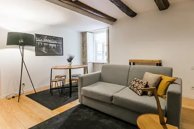 a living room with a couch and a table at Stay In Apartments in Porto