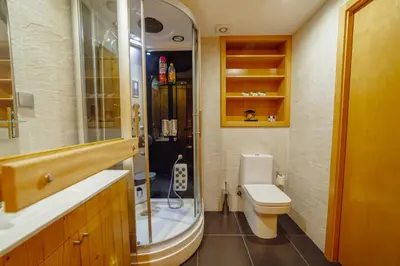 a bathroom with a toilet and a glass shower at OPORTO GUEST Oliveira House in Porto