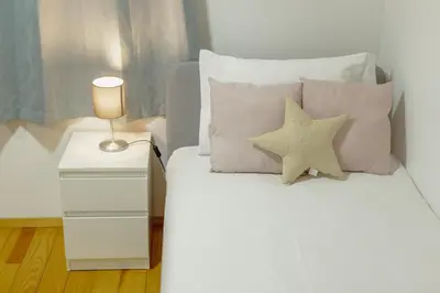 a bedroom with a bed with two pillows and a lamp at OPORTO GUEST Oliveira House in Porto