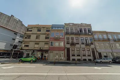 a group of buildings on a city street with cars at OPORTO GUEST Bonfim Apartment in Porto
