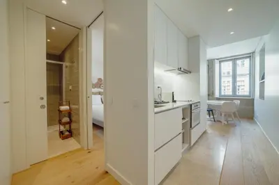 a white kitchen with a sink and a counter at OPORTO GUEST Bonfim Apartment in Porto
