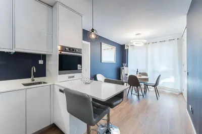 a kitchen and dining room with a table and chairs at GuestReady - Shades of Blue with Balcony in Porto