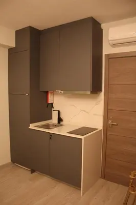 a kitchen with dark green cabinets and a sink at Apartment Art Jazz Music in Porto