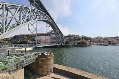 a bridge over a river next to a body of water at FLH Porto Clérigos Luxury Apartments in Porto