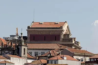 a large building with a clock tower in a city at Lóios 66 by LovelyStay in Porto