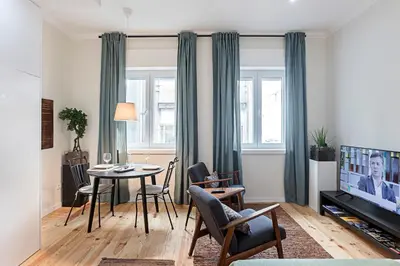 a living room with a table and a tv at 150 Rivoli Apartments by LovelyStay in Porto