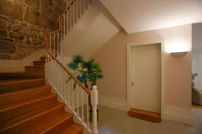 a staircase in a home with a white door at 4CITY FLAT CAMARÃO in Porto