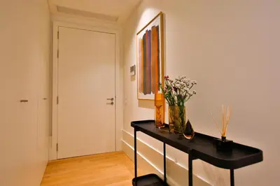 a room with a black dresser with flowers on it at 4CITY FLAT CAMARÃO in Porto