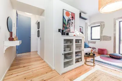 a living room with white cabinets and a blue door at OPO Bonjardim 902 II in Porto