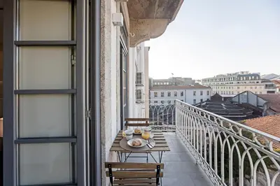a table on a balcony with a view of the city at 31 Janeiro 157 - Charming 1BR Flat w/ AC & Balcony by LovelyStay in Porto