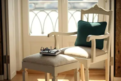 a pair of glasses sitting on a chair in front of a window at 1872 River House by Olivia in Porto