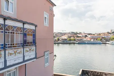 a building with a view of a body of water at 1872 River House by Olivia in Porto