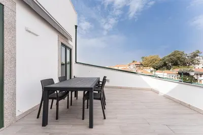 a black table and chairs on a balcony with a view at GuestReady - The Other Side in Porto