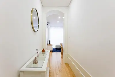 a white hallway with a mirror and a sink at Casinha da Formosa by Oporto Soul in Porto