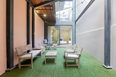 a group of chairs and tables in a room at Casinha da Formosa by Oporto Soul in Porto