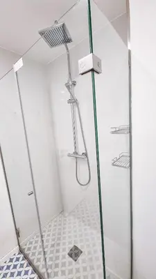 a bathroom with a shower with a glass door at Jardim do Morro Haus in Vila Nova de Gaia