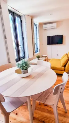 a living room with a table and a couch at Jardim do Morro Haus in Vila Nova de Gaia