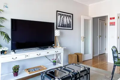 a living room with a flat screen tv on a white entertainment center at River 9 and City View Porto Gaia by MP in Vila Nova de Gaia
