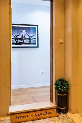 an open door with a picture of a plane on the wall at River 9 and City View Porto Gaia by MP in Vila Nova de Gaia