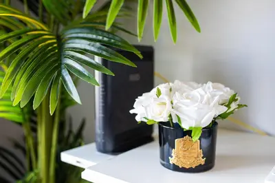 two vases filled with white flowers sitting on a table at River 9 and City View Porto Gaia by MP in Vila Nova de Gaia