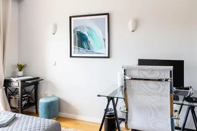 a room with a desk and a chair and a picture on the wall at River 9 and City View Porto Gaia by MP in Vila Nova de Gaia