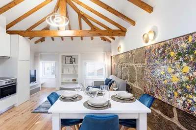a dining room with a white table and blue chairs at Modern Cativo Apartment by LovelyStay in Porto