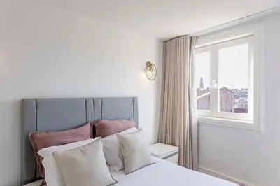 a bedroom with a large bed with a window at Modern Cativo Apartment by LovelyStay in Porto