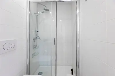 a shower with a glass door in a bathroom at Modern Cativo Apartment by LovelyStay in Porto