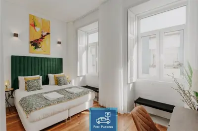 a bedroom with a bed and two windows at Bicycle Luxury House, parking, downtown near metro in Porto