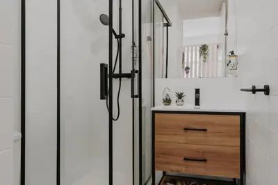 a bathroom with a shower and a wooden dresser at Bicycle Luxury House, parking, downtown near metro in Porto