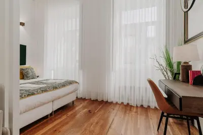 a bedroom with a bed and a desk and a window at Bicycle Luxury House, parking, downtown near metro in Porto