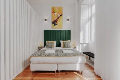 a bedroom with a large bed with a green headboard at Bicycle Luxury House, parking, downtown near metro in Porto