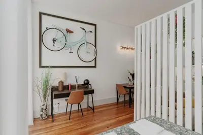 a living room with a bike hanging on the wall at Bicycle Luxury House, parking, downtown near metro in Porto