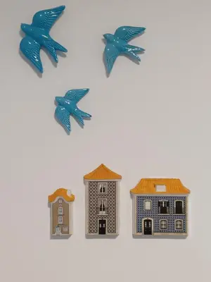 a group of toy houses and birds on a white background at Casa do Barqueiro - Porto in Porto