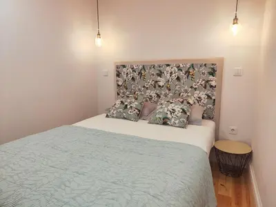 a bedroom with a bed with two pillows on it at Cristelo 2 - near the river Porto in Porto