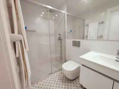 a bathroom with a shower and a toilet and a sink at Cristelo 2 - near the river Porto in Porto